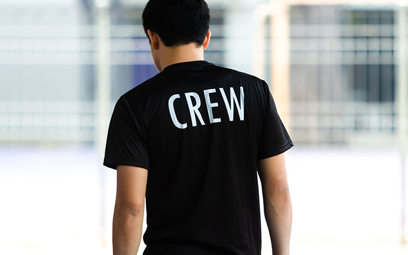 Back view of a young man wearing black CREW shirt