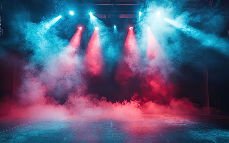 Illuminated stage with scenic lights and smoke on dark background.